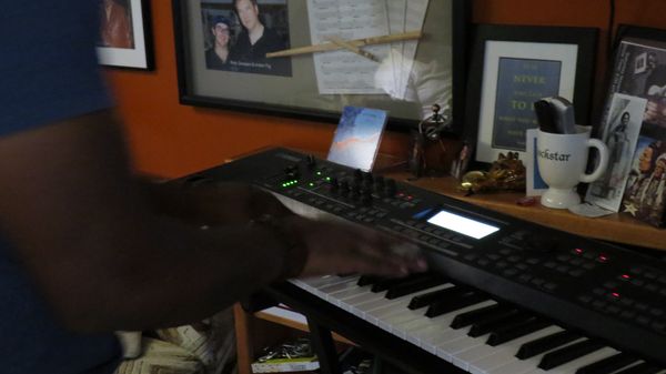 Hands on a synth keyboard